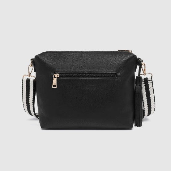 Black handbag with white strap on a light gray background