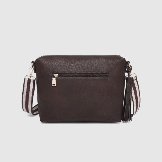 Brown handbag with a striped strap on a light gray background