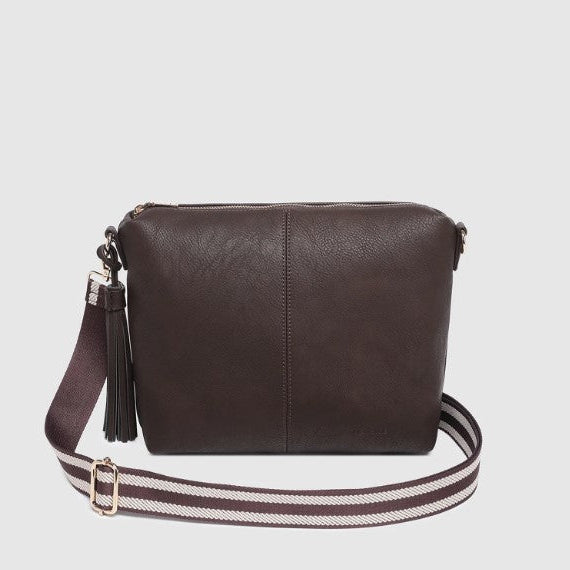 Brown crossbody bag with a striped strap on a light gray background