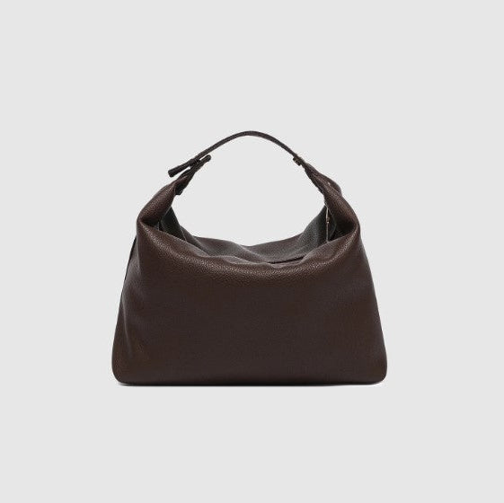 Brown cosmetic bag on a light gray background