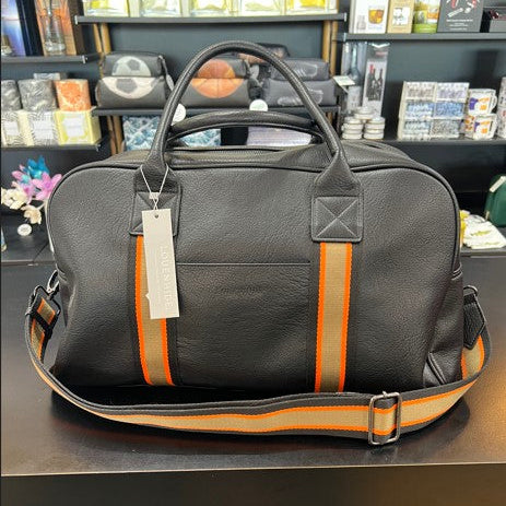 Black leather bag with orange stripes and a tag on a reflective surface.