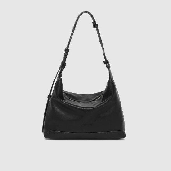 Black handbag on a light gray background
