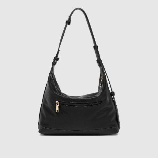 Black handbag with a shoulder strap on a light gray background