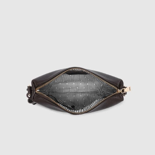 Interior of a brown bag with gold zipper on a light gray background