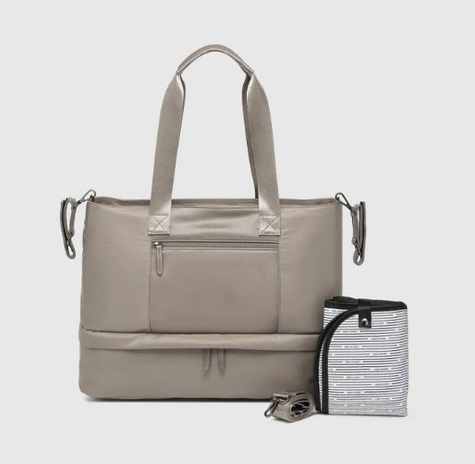 Beige tote bag with a baby change mat on a light gray background