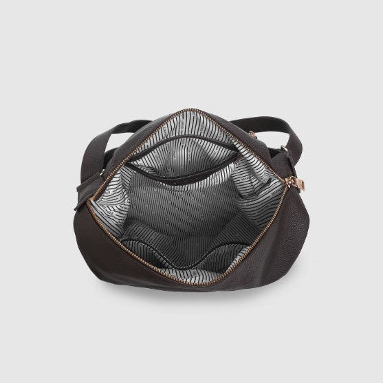 Brown handbag with a textured interior on a light gray background
