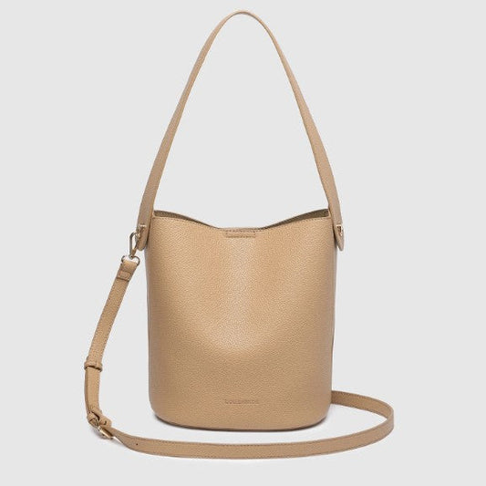A light tan pebbled leather bucket bag with a matching shoulder strap, displayed against a solid light gray background.
