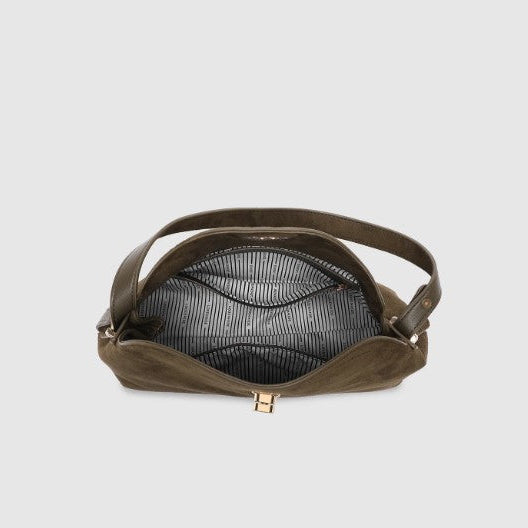 Brown leather handbag with gold clasp on a light gray background