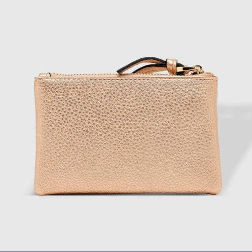 Pink champagne textured wallet with a gold zipper on a light gray background