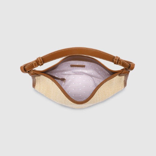 Woven bag with brown leather strap on a light gray background