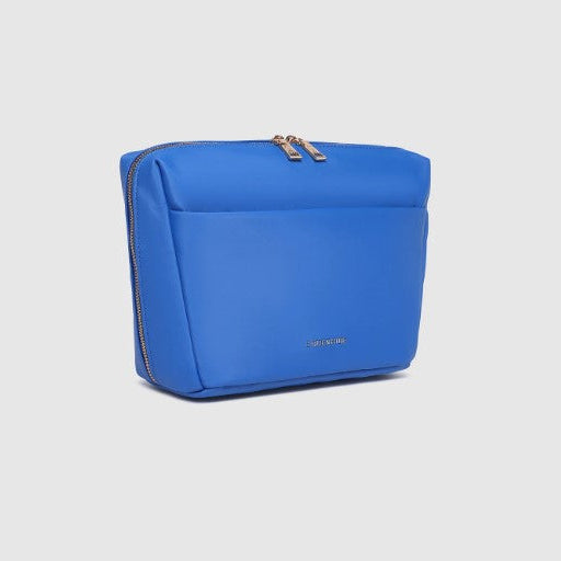 Blue cosmetic bag with gold zipper on a light gray background
