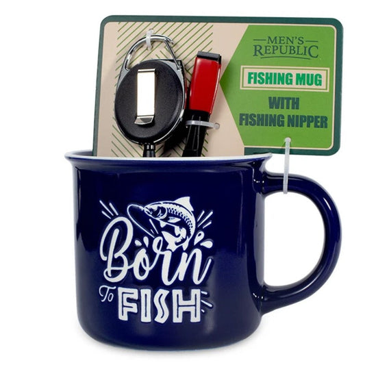 A dark blue ceramic mug with a white 'Born to Fish' graphic and fish illustration, shown with its retail backing card. The backing card reads 'Men's Republic' and 'Fishing Mug with Fishing Nipper,' and a black-and-red fishing nipper is visible inside the mug.