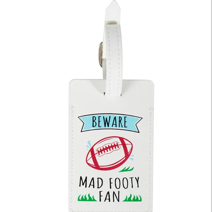 A white leather luggage tag with a printed graphic that reads 'BEWARE MAD FOOTY FAN' alongside a red football illustration, shown on a plain white background.