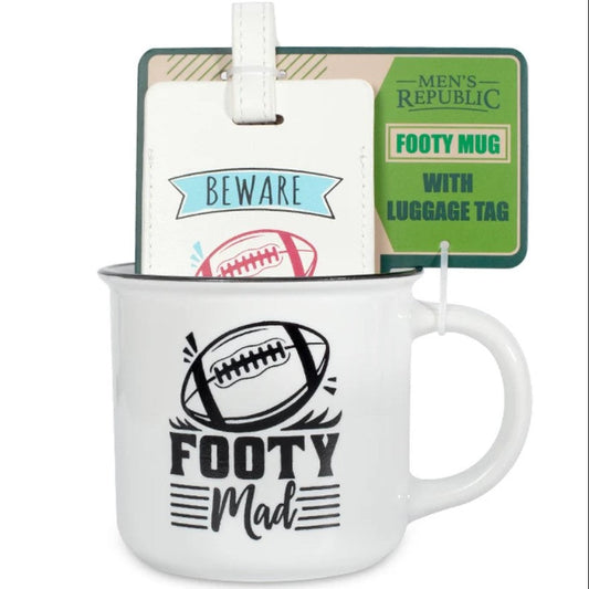 White ceramic football mug with a black football graphic and the words 'FOOTY Mad' on the front, shown with its luggage tag attached. The tag has a green panel reading 'Men's Republic' and 'Footy Mug with Luggage Tag,' plus a white tag that says 'Beware' with a football illustration.