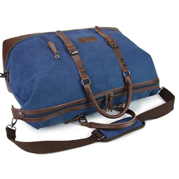 Blue duffel bag with brown straps on a white background