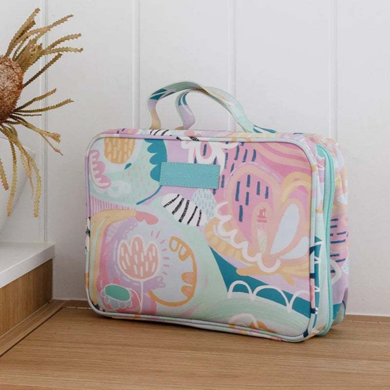 Colorful toiletry bag with abstract design on a wooden floor
