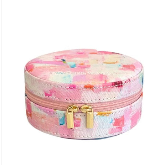 Round jewelry box with floral pattern and gold zipper on a white background