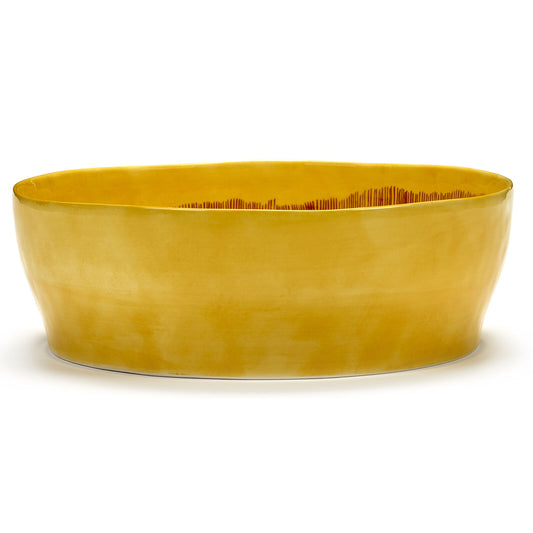 Yellow salad bowl on a white background