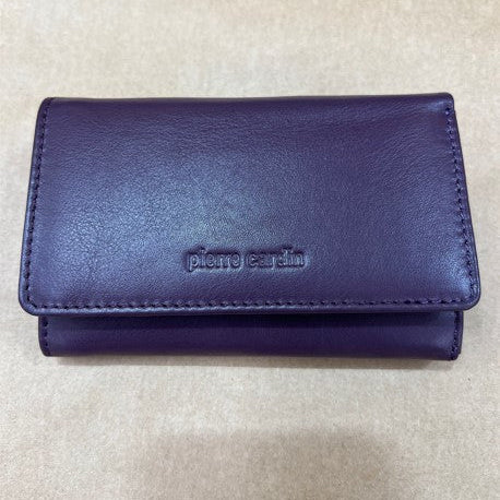 Purple wallet with 'Pierre Cardin' branding on a beige background