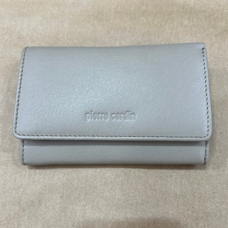 Taupe wallet with 'pierre cardin' branding on a beige background