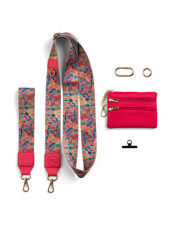 Set of pink and multicolored bag strap, red cardholder, and black clip on a white background