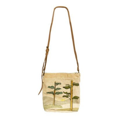 Textured shoulder bag with leaf design on a white background