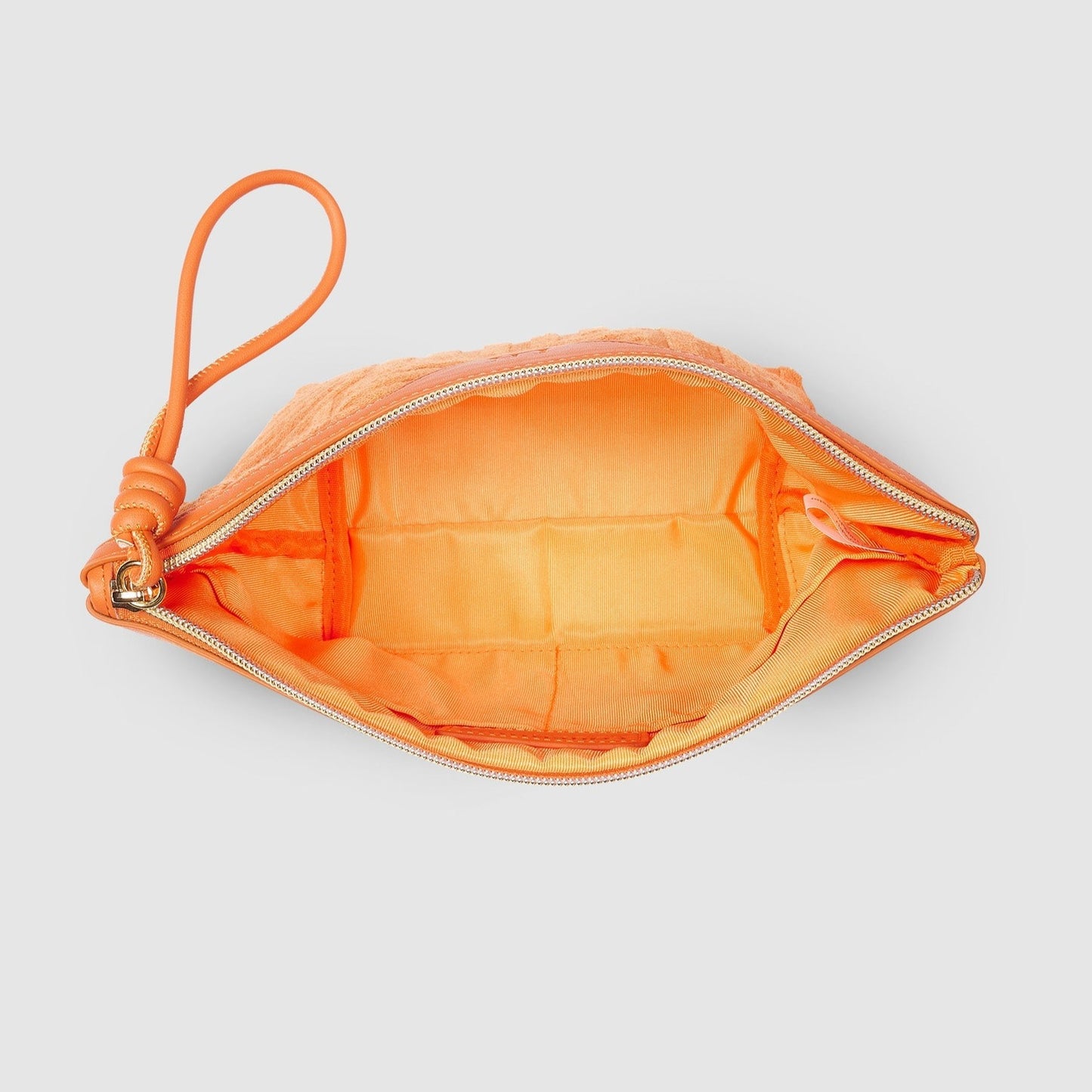 Orange cosmetic bag inside