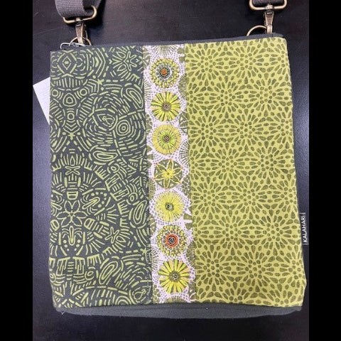 Green patterned bag with a strap on a black background