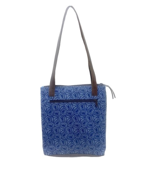 Blue patterned bag with a brown strap on a white background