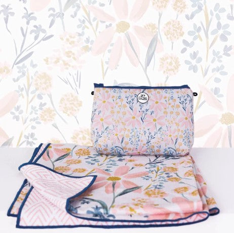 Floral-patterned quick dry towel and bag set on a white surface with a floral background