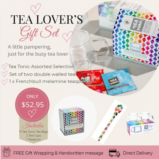Tea Lover's Gift Set with tea bags, cups, and a spoon on a white background