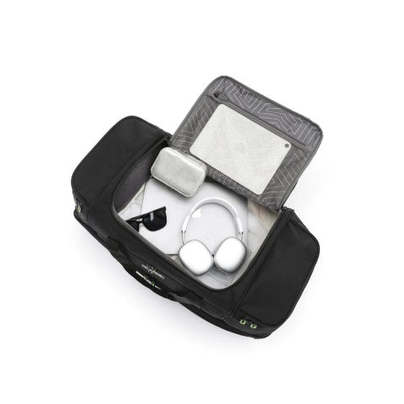 Black duffel with electronic devices inside on a white background