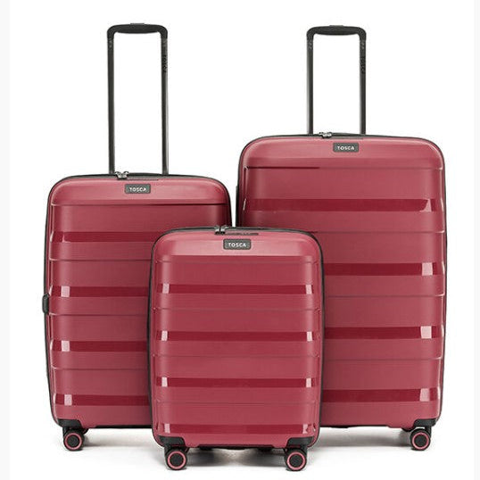 Three red suitcases of different sizes with 'Tosca' branding on a white background