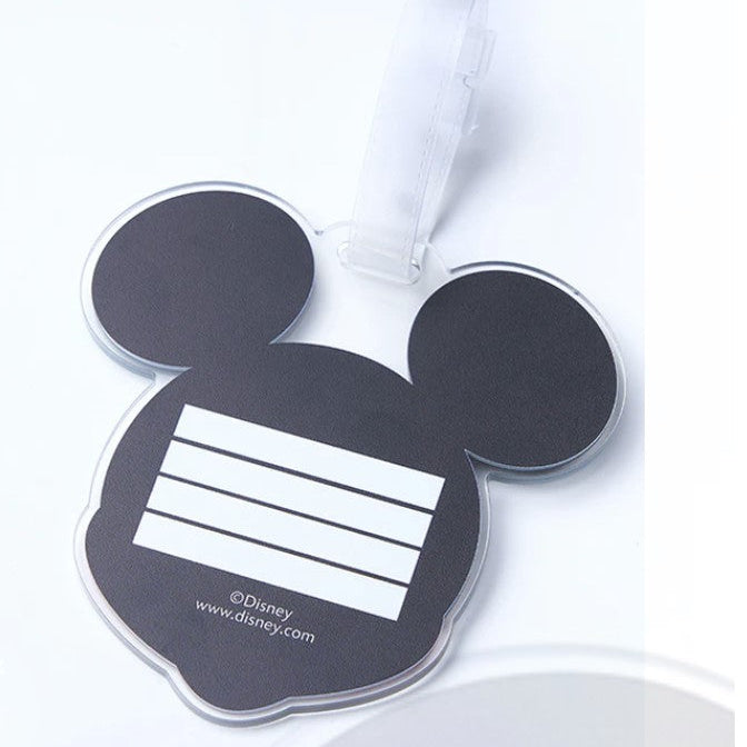 Black Mickey Mouse head-shaped tag with a white label on a white background