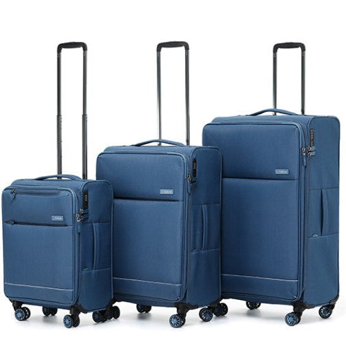 Set of three blue suitcases of different sizes on a white background