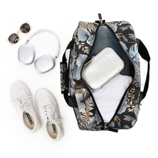Floral-patterned backpack with white sneakers, sunglasses, and earbuds on a white background