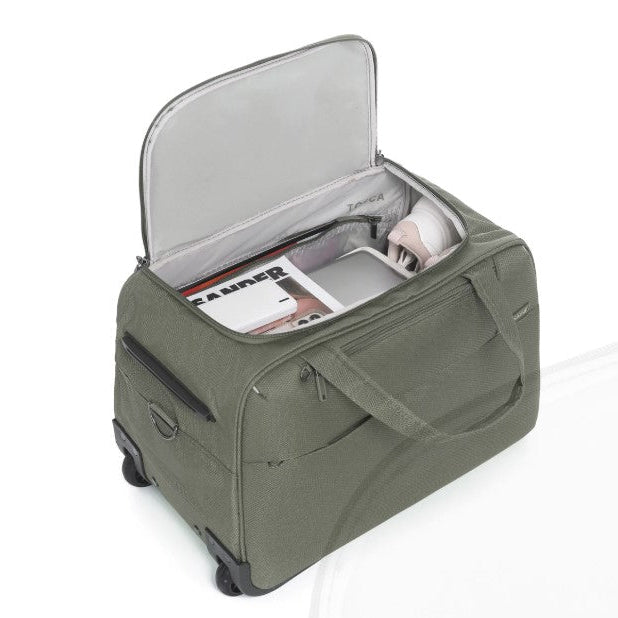 Green suitcase with open lid on a white background