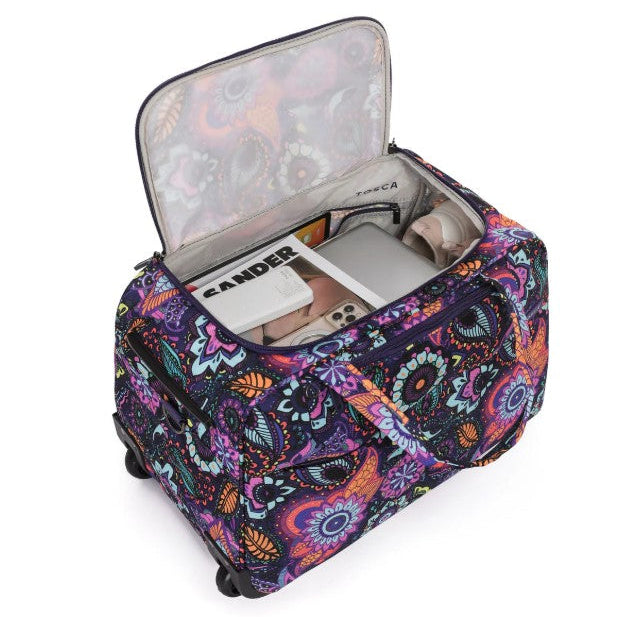 Colorful patterned suitcase with open lid showing contents on a white background