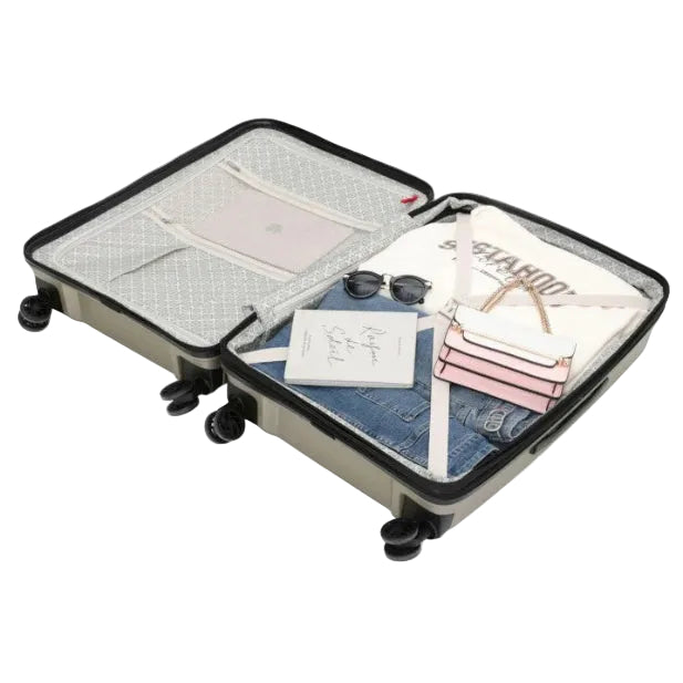 Open suitcase with clothes, sunglasses, and a notebook inside on a white background