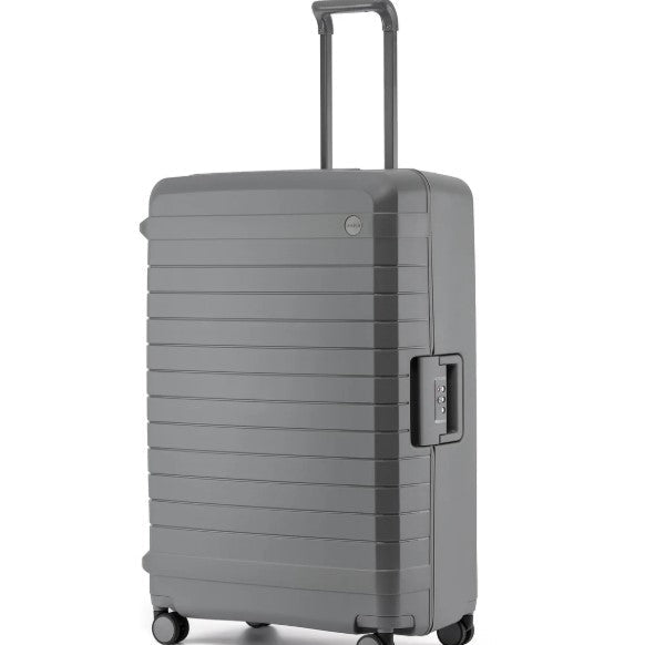 Gray suitcase with a textured surface on a white background