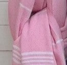 Close-up of a pink towel with white stripes on a white background
