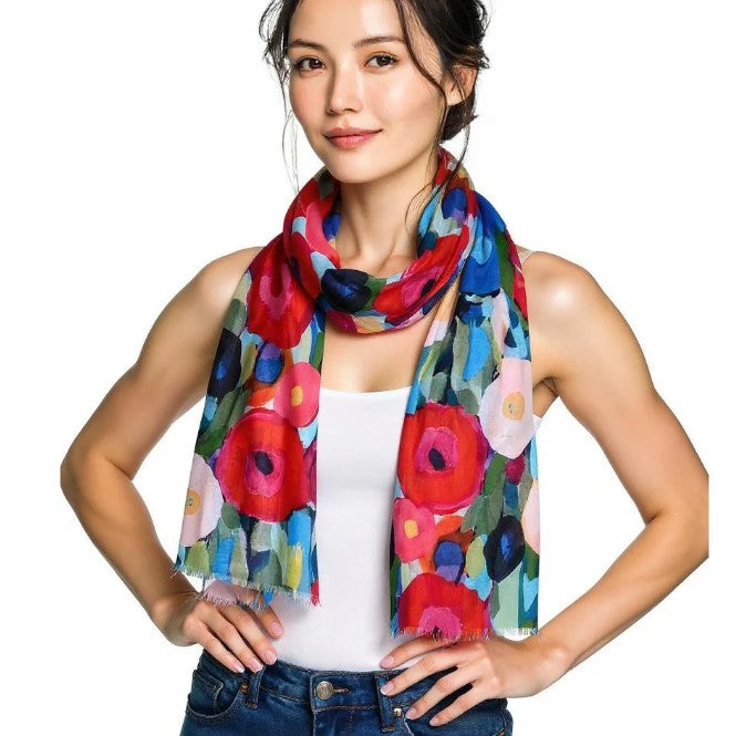 Woman wearing a colorful floral scarf on a white background