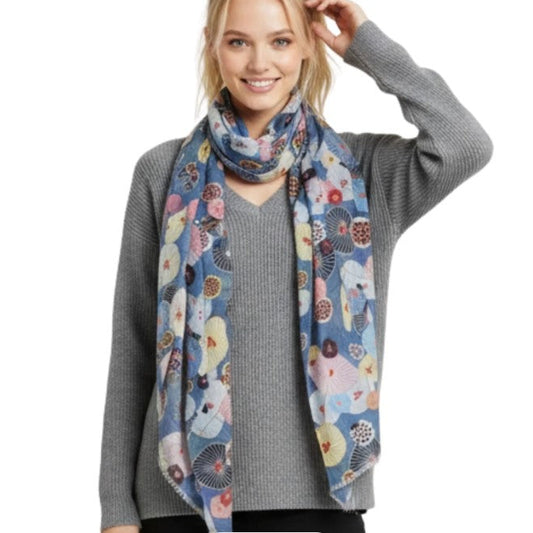 Woman wearing a colorful floral scarf on a white background