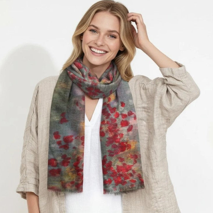 Woman wearing a colorful floral scarf on a white background
