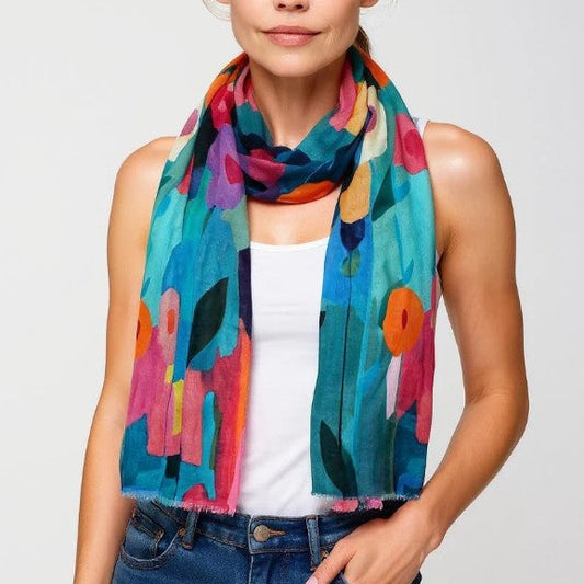 Woman wearing a colorful scarf with abstract patterns on a plain background