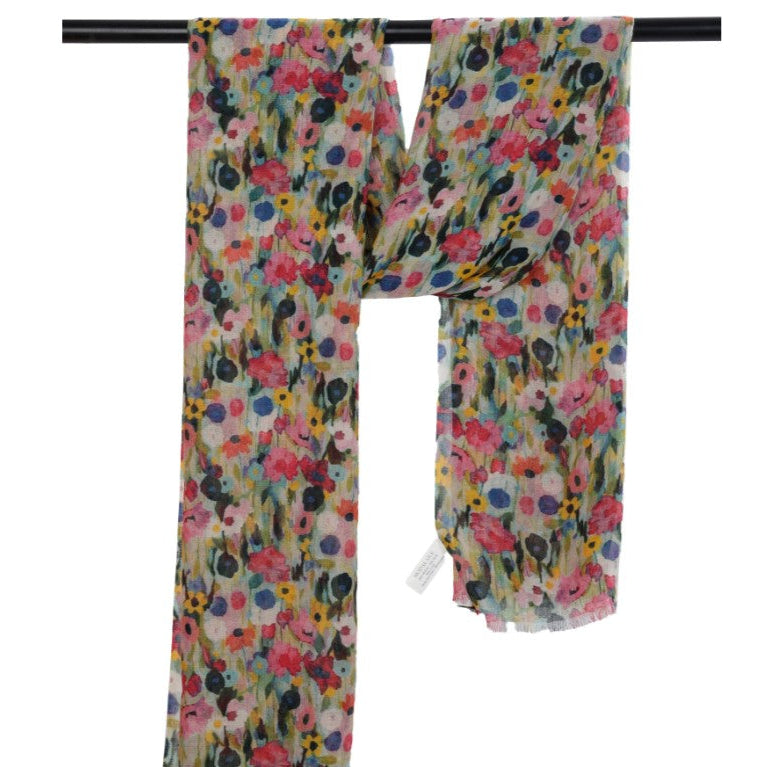 Floral patterned scarf on a black rod with a white background