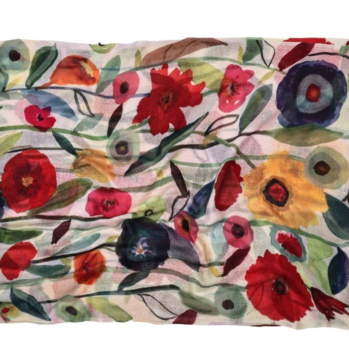 Floral patterned fabric with red, blue, yellow, and pink flowers on a white background