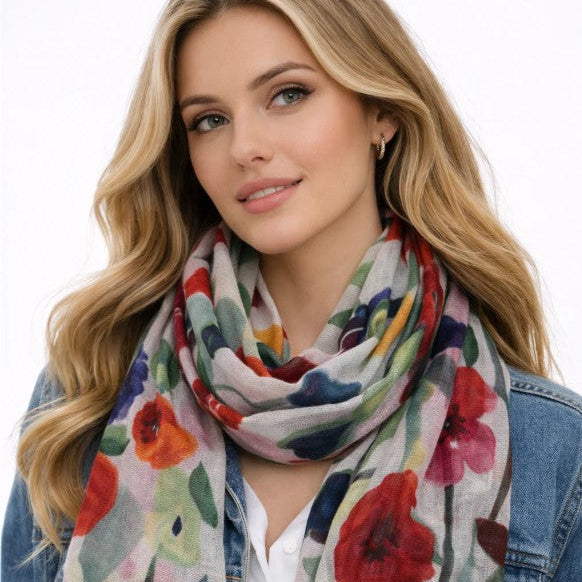 Woman wearing a colorful floral scarf on a white background