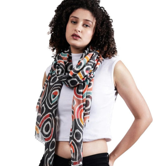 Woman wearing a colorful patterned scarf on a white background