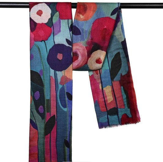 Colorful floral-patterned scarf on a black rod against a white background